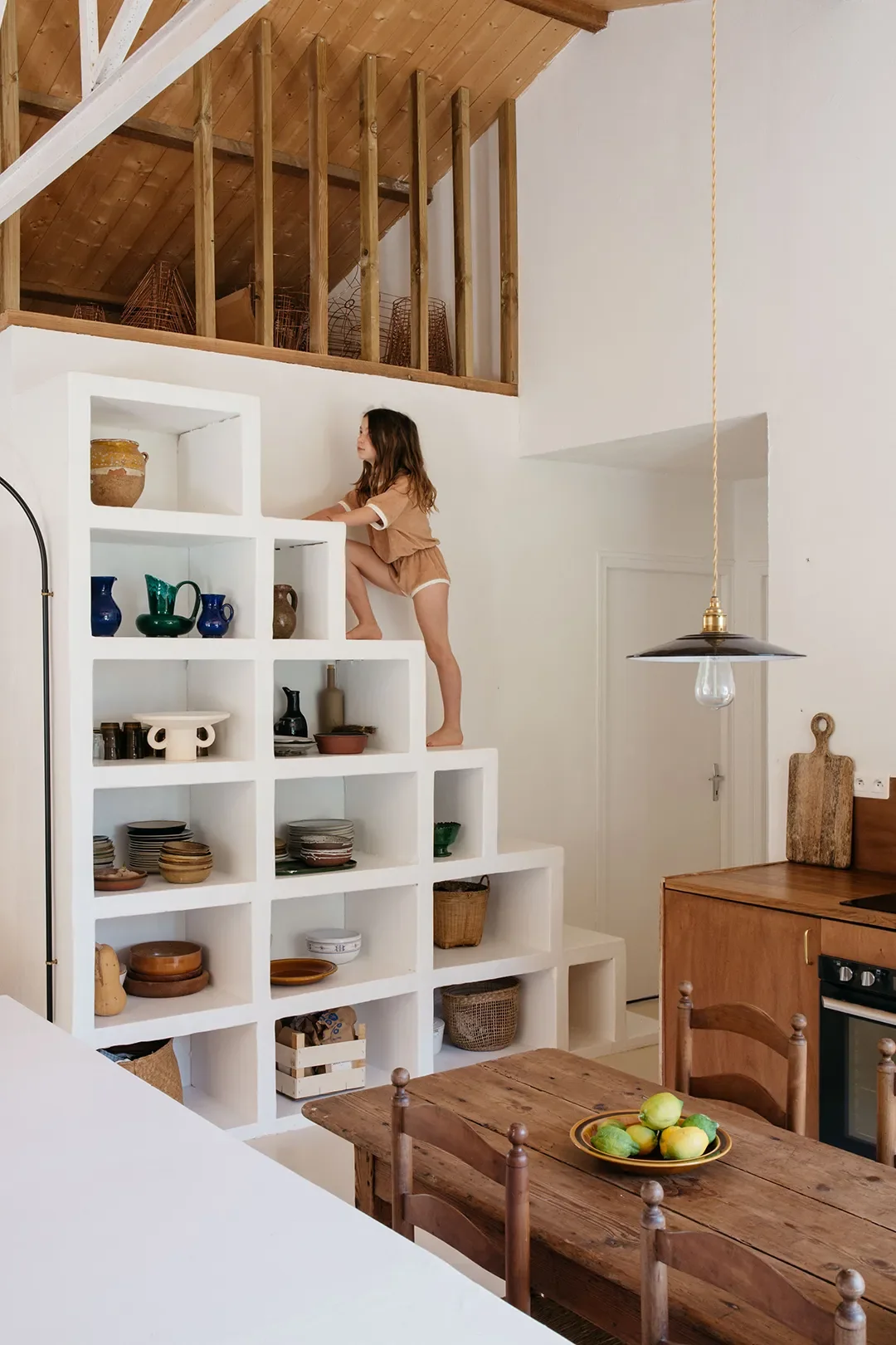 A Plaster Staircase Masquerades as Kitchen Storage in This Serene Seaside French Home