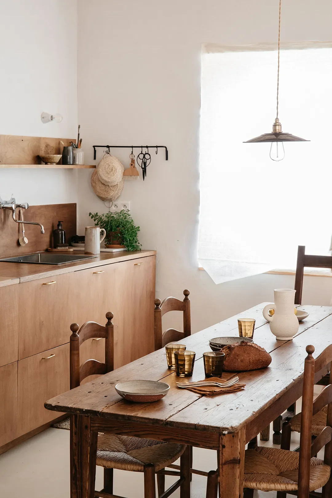 A Plaster Staircase Masquerades as Kitchen Storage in This Serene Seaside French Home