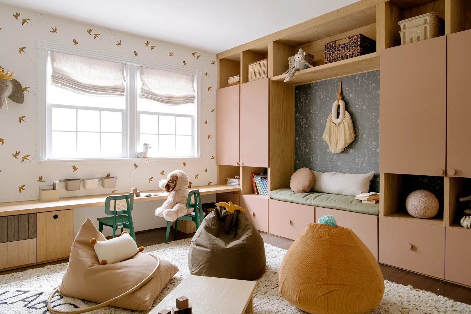 A Wall of Pink Cabinets Turned This Top-of-Stairs Space Into a Chic Playroom