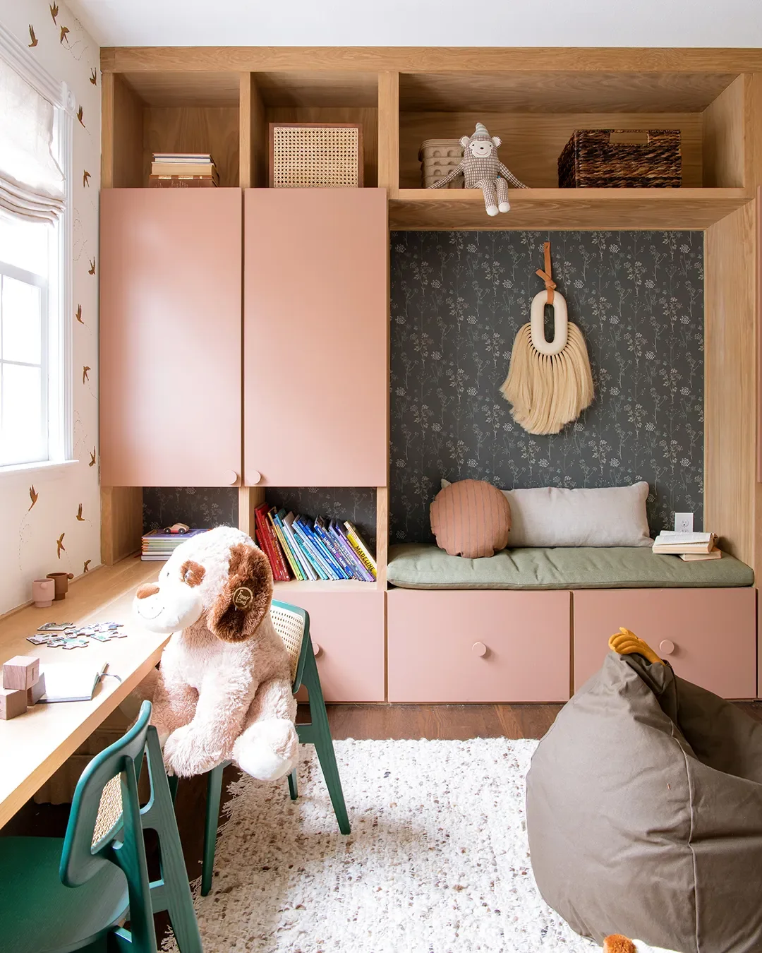A Wall of Pink Cabinets Turned This Top-of-Stairs Space Into a Chic Playroom